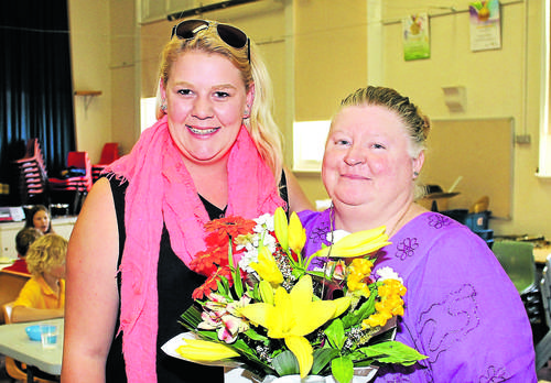 Leonie (R) is farewelled with flowers as she hands over her role to Kelsie (L). Photo: Thomas McCoy.